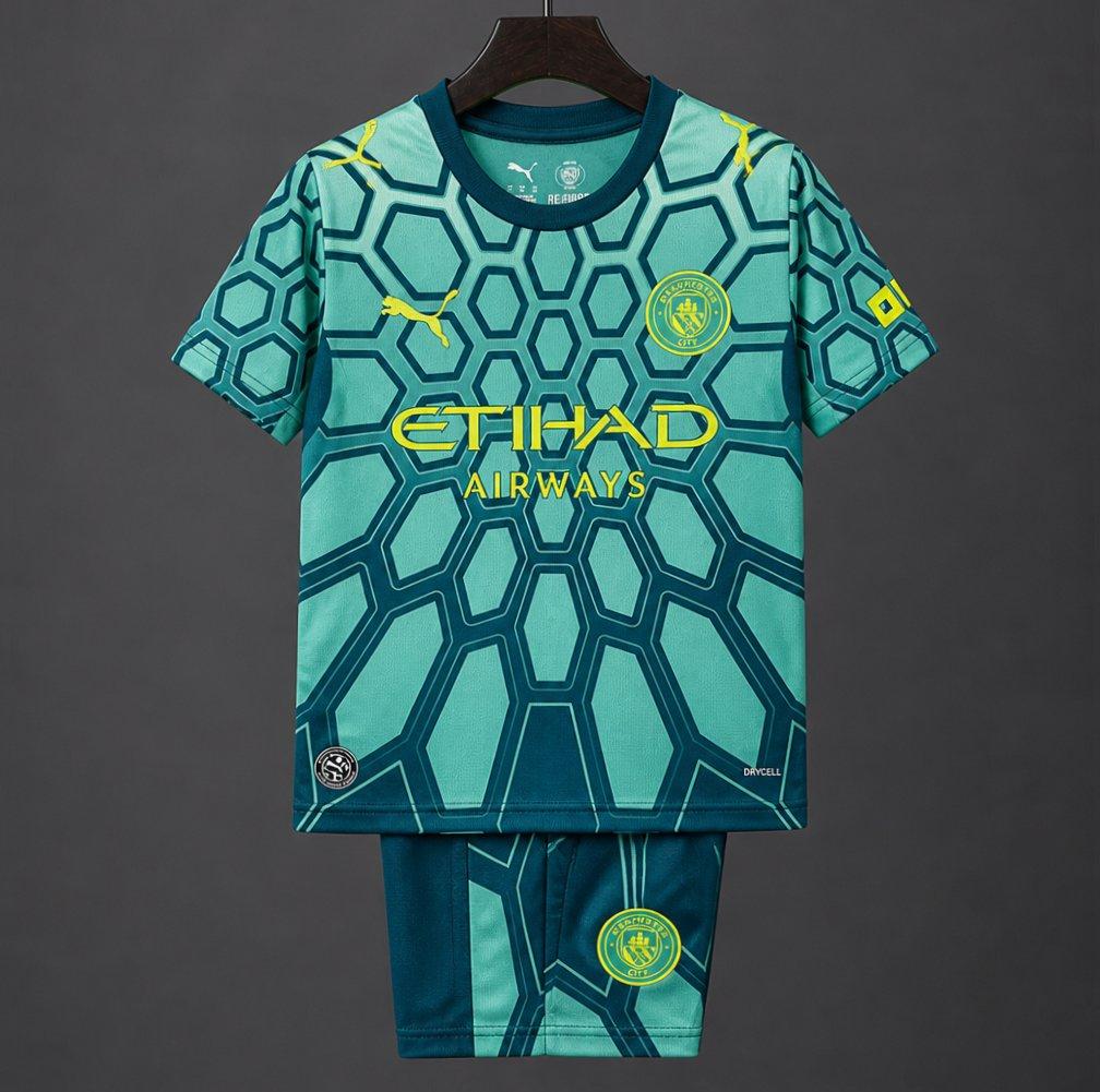 26/27 Kids Manchester City Vibrant Green Goalkeeper Shirt With Dark Blue Geometric Pattern.